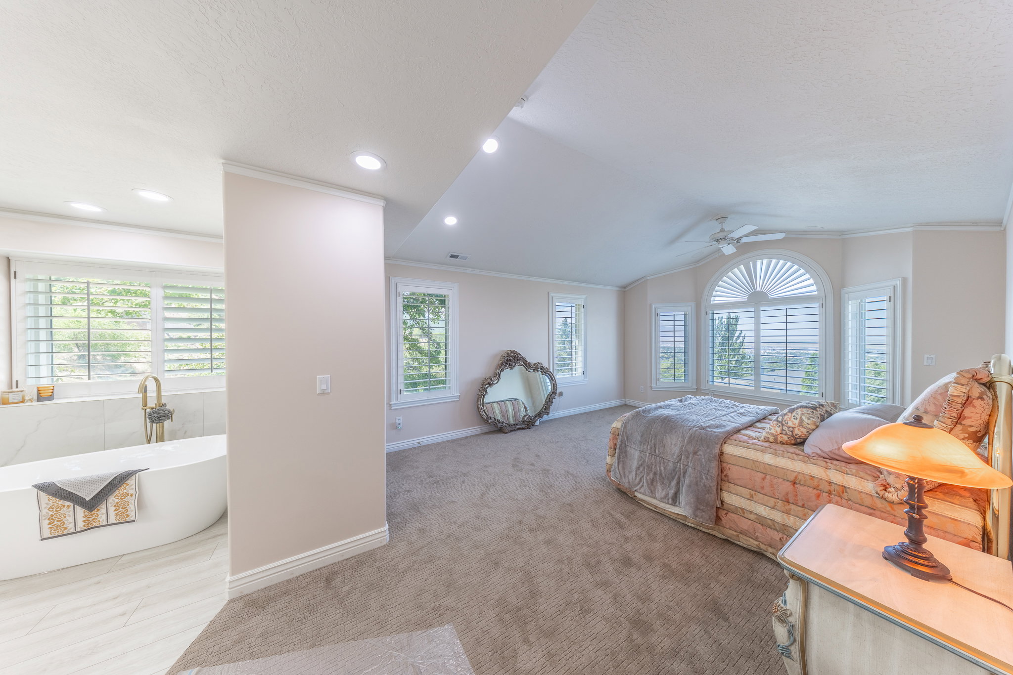 Bedroom with crown molding, light carpet, and ceiling fan