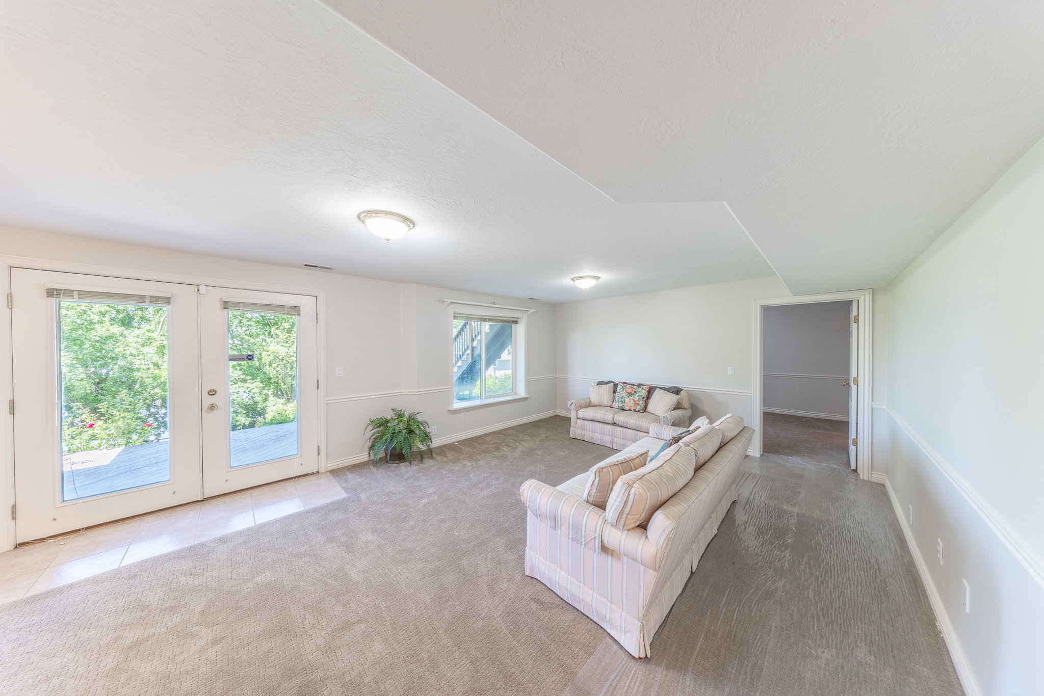 Living room featuring french doors and light carpet