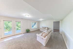 Living room featuring french doors and light carpet