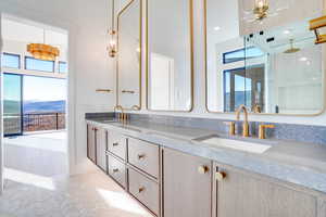 Full bath with double vanity and a shower stall
