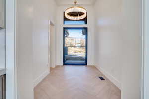 Entrance foyer with a high ceiling and parquet flooring