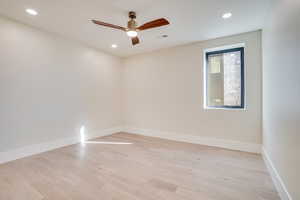 Spare room with ceiling fan, light wood-style flooring, and recessed lighting