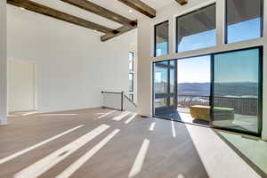 Unfurnished room with a mountain view and light wood-style flooring