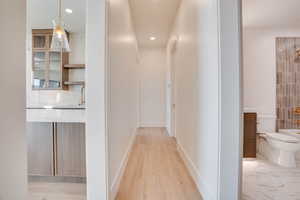 Hall featuring baseboards and recessed lighting