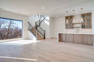 Unfurnished living room featuring light wood-type flooring and recessed lighting