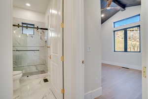Full bathroom with a marble finish shower, ceiling fan, recessed lighting, and vaulted ceiling