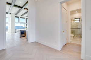 Hall featuring parquet floors, recessed lighting, wine cooler, beamed ceiling, and a mountain view