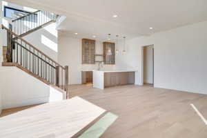 Unfurnished living room featuring light wood-style flooring and recessed lighting