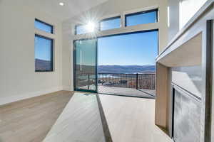 Spare room featuring a mountain view and light wood finished floors