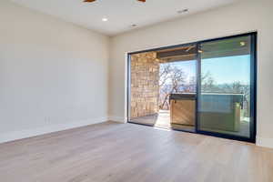 Spare room with light wood-type flooring, ceiling fan, and recessed lighting