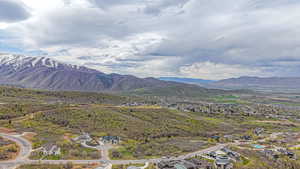 View of mountain backdrop featuring nearby suburban area