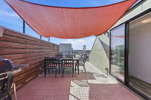 Balcony featuring outdoor dining area and grilling area