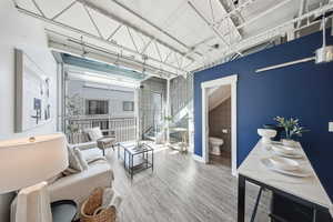Living room with light wood-style flooring and baseboards