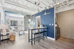 Dining space with light wood-type flooring and tile walls
