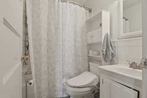 Bathroom featuring vanity and curtained shower