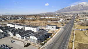Aerial overview of property's location with a mountainous background and nearby suburban area