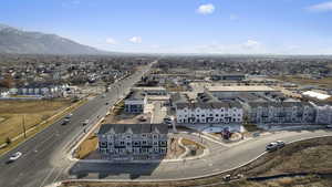 Aerial view of property's location with mountains and nearby suburban area