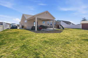 Rear view of property with a patio area, a fenced backyard, a playground, a ceiling fan, and stucco siding