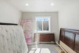 Bedroom featuring light colored carpet and recessed lighting