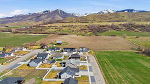 View of rural area with a mountain backdrop and nearby suburban area