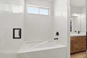 Full bath with a bath and vanity