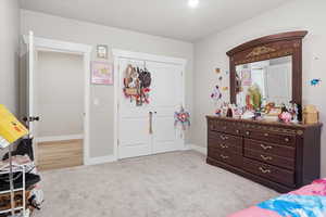 Bedroom featuring a closet and light carpet
