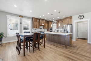 Dining space featuring recessed lighting and light wood-style floors
