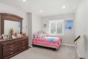 Bedroom featuring light colored carpet and recessed lighting