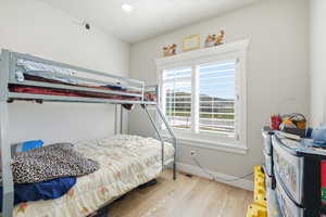 Bedroom with light wood finished floors and recessed lighting