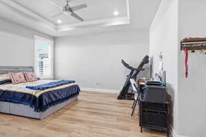 Bedroom featuring light wood-style flooring, a ceiling fan, recessed lighting, and crown molding