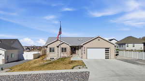 View of front of home featuring an attached garage, driveway, a residential view, a gate, and stucco siding