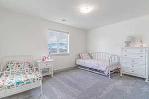 Bedroom featuring carpet flooring and baseboards
