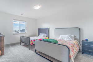 Carpeted bedroom with baseboards