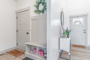 Entrance foyer featuring light wood-style flooring and baseboards