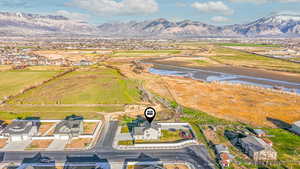 Aerial view of sparsely populated area featuring a water and mountain view and nearby suburban area