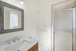 Bathroom with vanity and a shower stall