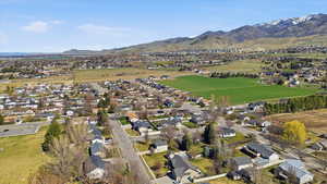 Aerial view of property's location with nearby suburban area and a mountain backdrop