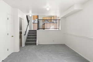 Staircase with carpet floors and baseboards