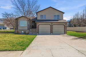 View of front of property featuring brick siding, driveway, an attached garage, and a shingled roof