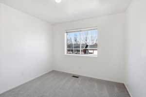 Carpeted empty room with baseboards