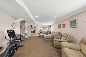 Carpeted living area featuring crown molding and recessed lighting