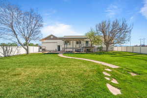Rear view of property featuring covered porch