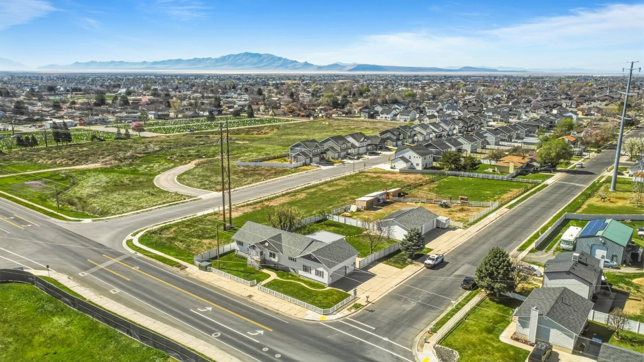 Aerial perspective of suburban area featuring a mountain backdrop