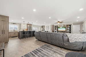 Living area with recessed lighting, a ceiling fan,