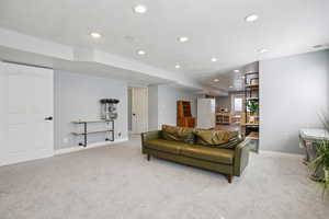 Living room with light carpet and recessed lighting