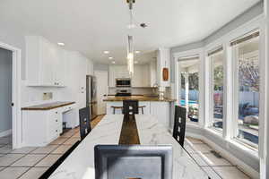 Dining space featuring baseboards and recessed lighting