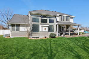 Rear view of property featuring a patio area, roof with shingles, and stucco siding