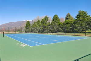 View of tennis court featuring a mountain view