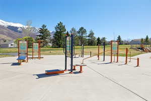 View of play area with a yard and a mountain view