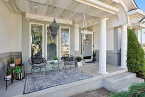 Doorway to property with a porch and stucco siding
